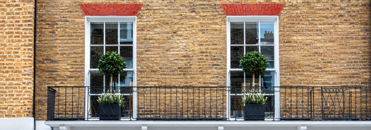 Arched timber sash window beside the title “Do you need planning permission to replace your windows?”
